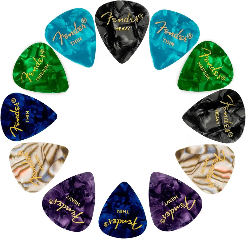 Fender 351 shape celluloid picks in thin, medium, and heavy gauges arranged in a circle, one of the best guitar picks for beginners.